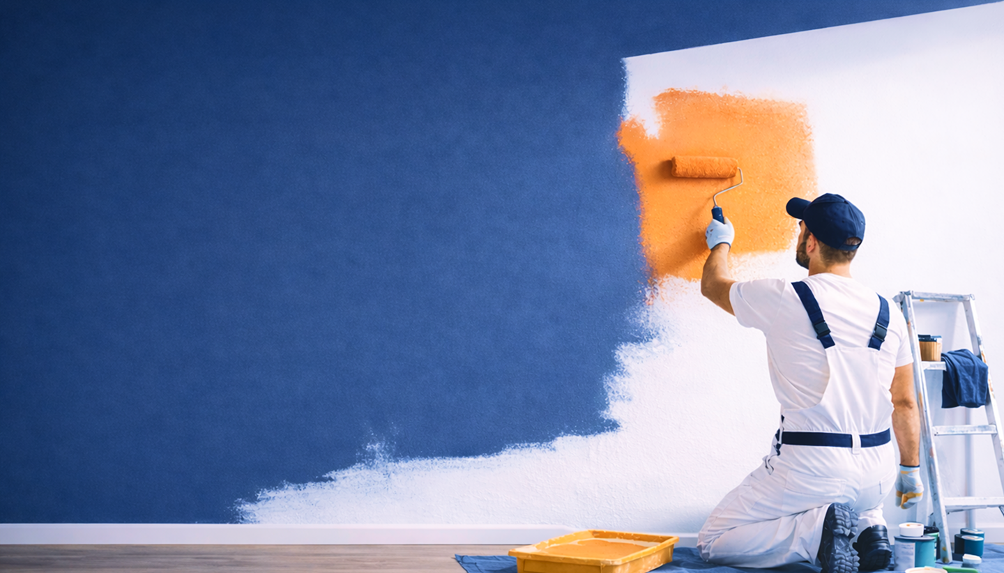 Professional painter painting wall